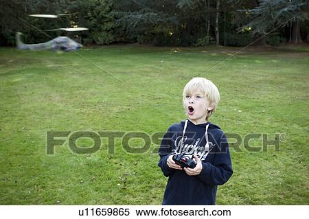 Boy with remote Helicopter View Large Photo Image Stock Photography - Boy with remote Helicopter. Fotosearch