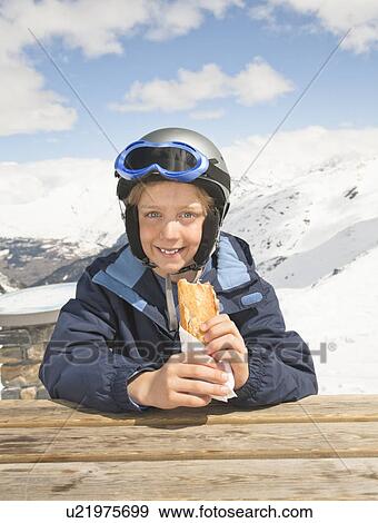 Boy with sandwich in snowy mountains View Large Photo Image Stock Photo - Boy with sandwich in snowy mountains. Fotosearch