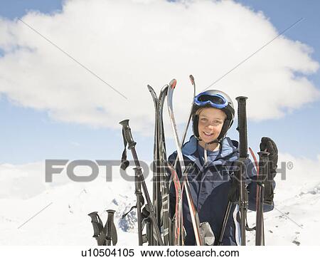 Stock Photography - Boy with skis in mountain scene. Fotosearch