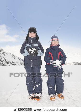 Stock Photography - Boys (8-11) holding snowballs. Fotosearch