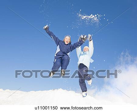 Boys (8-11) jumping in snow View Large Photo Image Stock Image - Boys (8-11) jumping in snow. Fotosearch