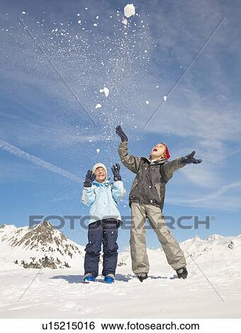 Boys (8-11) throwing snow in the air View Large Photo Image Stock Photograph - Boys (8-11) throwing snow in the air. Fotosearch
