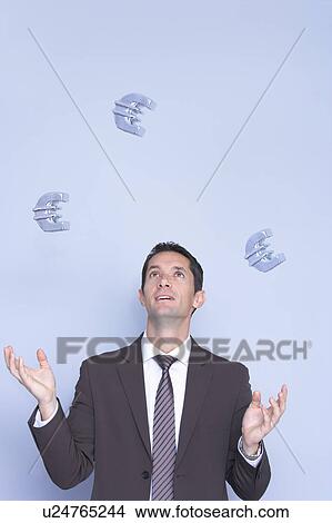 Picture - business man juggling with euros. Fotosearch