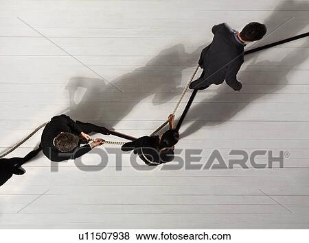 Stock Photo - Business man leading others with rope. Fotosearch
