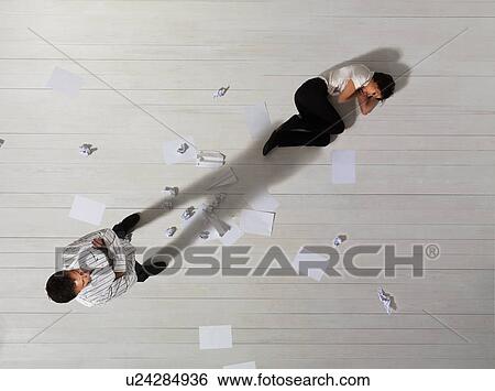 Stock Photograph - Business man standing over woman. Fotosearch