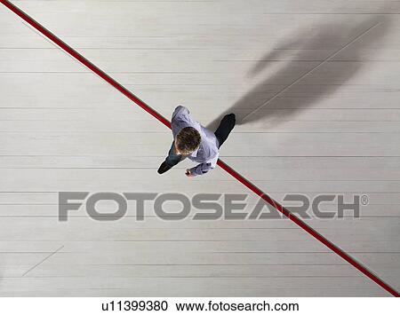 Business man stepping over a red line View Large Photo Image Stock Image - Business man stepping over a red line. Fotosearch