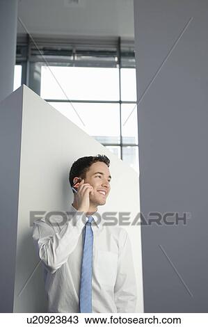 Business man using mobile in office View Large Photo Image Stock Image - Business man using mobile in office. Fotosearch