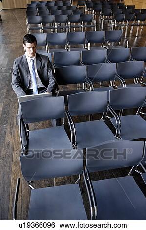 Stock Photograph - Business man working with laptop. Fotosearch