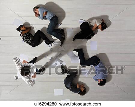 Business men and women asleep on floor View Large Photo Image Stock Image - Business men and women asleep on floor. Fotosearch