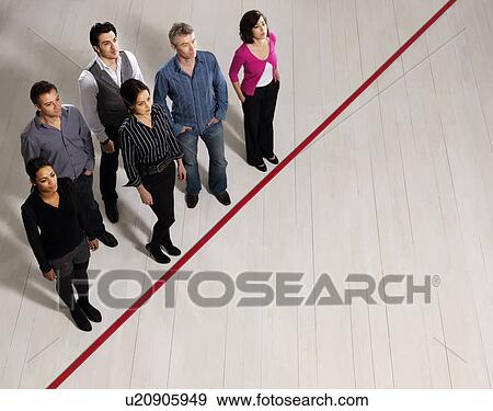 Business men and women by red line View Large Photo Image Stock Photo - Business men and women by red line. Fotosearch