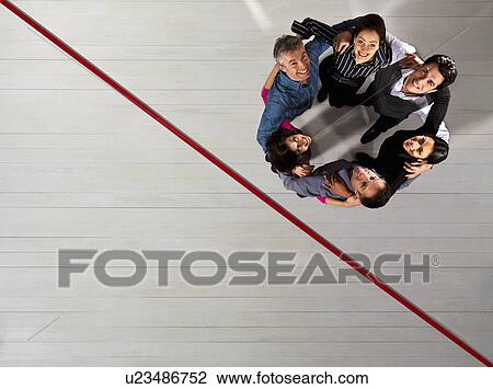 Stock Image - Business men and women in a circle. Fotosearch