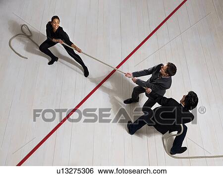 Business men pulling woman with rope View Large Photo Image Stock Photograph - Business men pulling woman with rope. Fotosearch