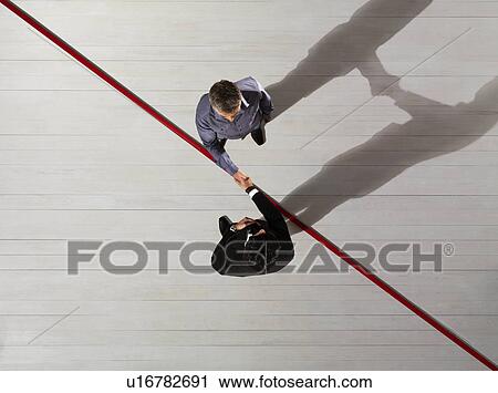Business men Shaking hands over red line View Large Photo Image Stock Image - Business men Shaking hands over red line. Fotosearch