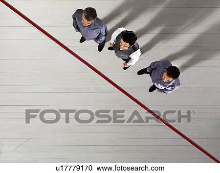 Business men standing by red line View Large Photo Image Stock Image - Business men standing by red line. Fotosearch
