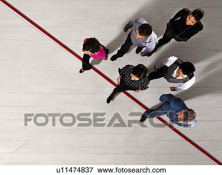 Business people crossing a red line View Large Photo Image Stock Photo - Business people crossing a red line. Fotosearch