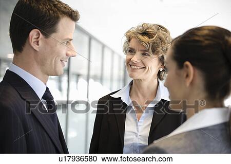 Stock Image - Business people having a conversation. Fotosearch