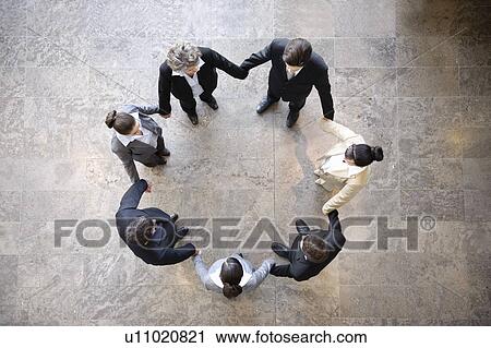 Business people holding hands in circle View Large Photo Image Stock Image - Business people holding hands in circle. Fotosearch