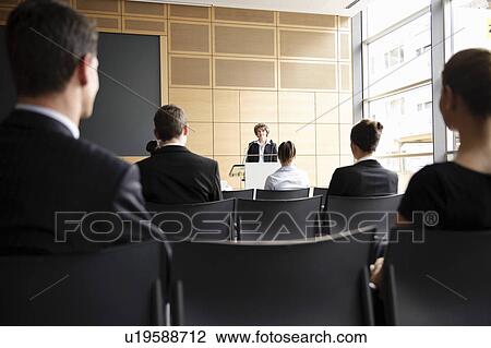Stock Image - Business people in seminar. Fotosearch