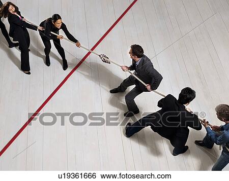 Business people playing tug of war View Large Photo Image Stock Photograph - Business people playing tug of war. Fotosearch