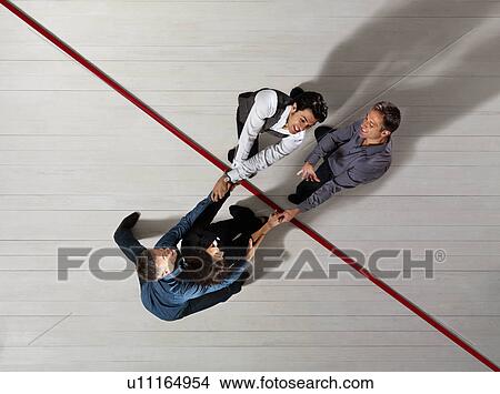 Picture - Business people pulling each other. Fotosearch