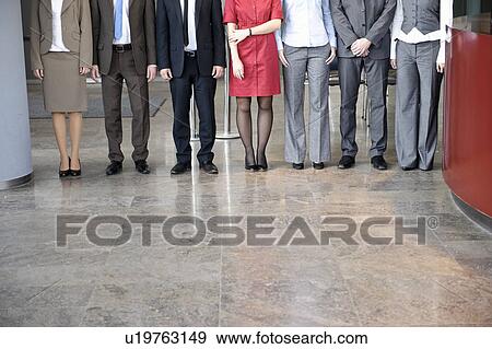 Stock Photo - Business people standing in line. Fotosearch