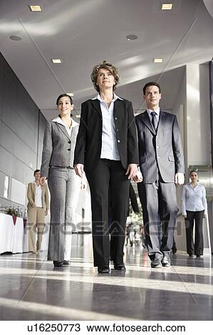 Business people walking towards camera View Large Photo Image Stock Image - Business people walking towards camera. Fotosearch