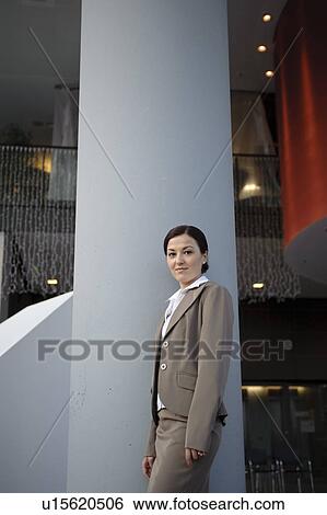 Business woman standing in building View Large Photo Image Stock Photograph - Business woman standing in building. Fotosearch