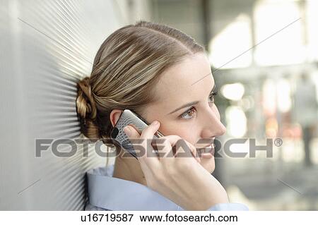Stock Photo - Business woman using mobile in office. Fotosearch