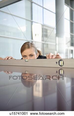 Business woman using spirit level View Large Photo Image Stock Image - Business woman using spirit level. Fotosearch