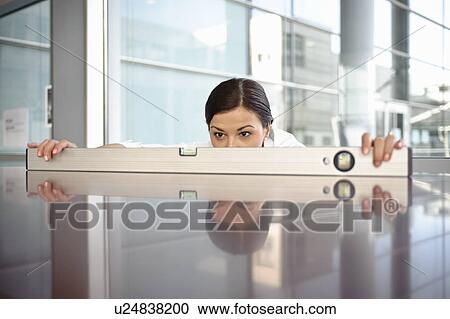 Business woman using spirit level View Large Photo Image Stock Image - Business woman using spirit level. Fotosearch
