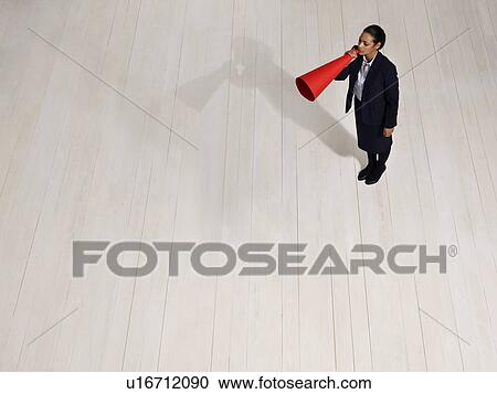 Stock Image - Business woman with mega phone. Fotosearch