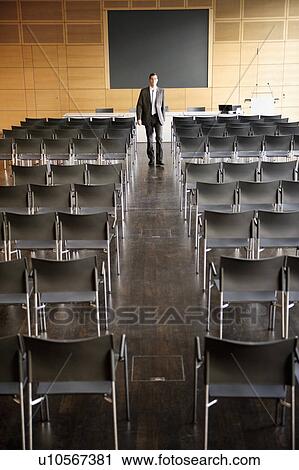 Businessman in empty conference room View Large Photo Image Stock Image - Businessman in empty conference room. Fotosearch