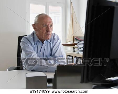 Stock Photo - Businessman in front of computer. Fotosearch