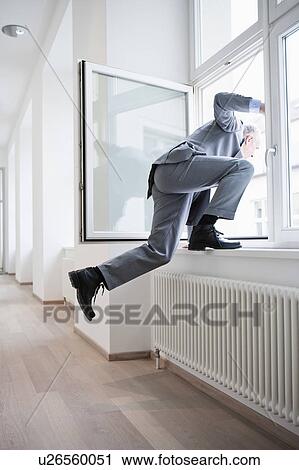 Businessman jumping out of window View Large Photo Image Stock Image - Businessman jumping out of window. Fotosearch