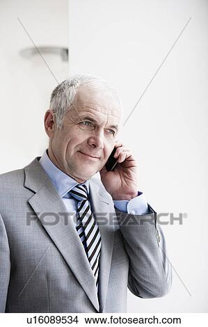 Businessman on cellphone View Large Photo Image Picture - Businessman on cellphone. Fotosearch