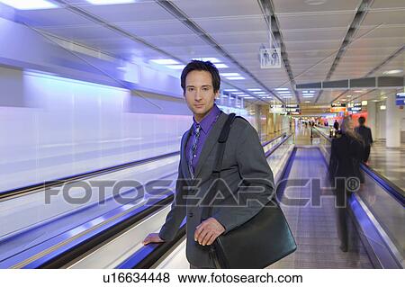 Stock Photo - businessman on conveyor belt, waiting. Fotosearch