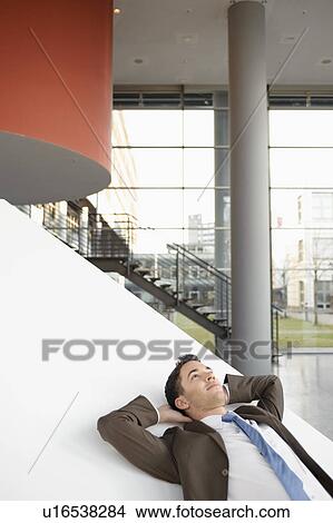 Businessman relaxing in office View Large Photo Image Picture - Businessman relaxing in office. Fotosearch