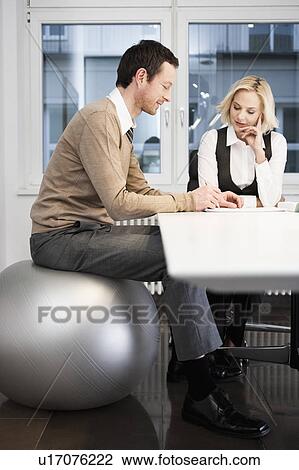 Businessman sitting on gym ball View Large Photo Image Stock Image - Businessman sitting on gym ball. Fotosearch