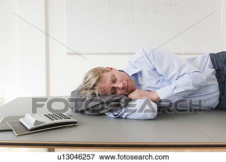 Stock Photo - Businessman sleeping on conference table. Fotosearch