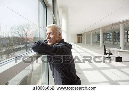 Businessman thinking about future office View Large Photo Image Stock Image - Businessman thinking about future office. Fotosearch