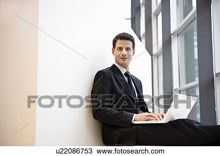 Stock Image - Businessman using laptop. Fotosearch