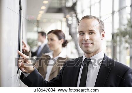 Businessman using touchscreen View Large Photo Image Picture - Businessman using touchscreen. Fotosearch