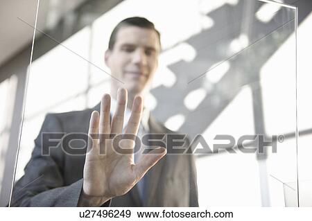 Businessman using touchscreen View Large Photo Image Stock Photo - Businessman using touchscreen. Fotosearch