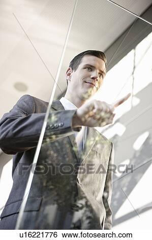 Stock Photograph - Businessman using touchscreen. Fotosearch