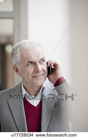 Businessman with cellphone View Large Photo Image Picture - Businessman with cellphone. Fotosearch