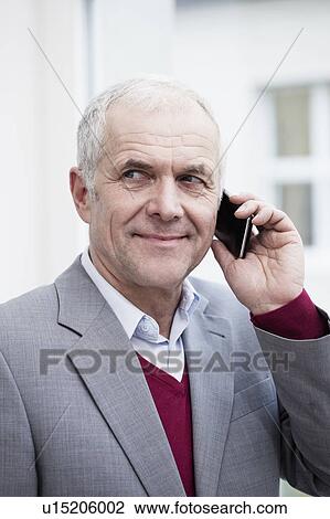 Businessman with handheld View Large Photo Image Stock Image - Businessman with handheld. Fotosearch