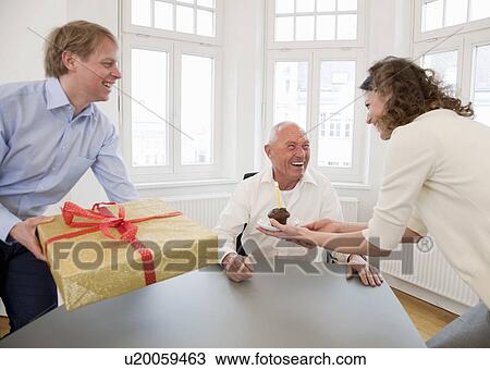 Stock Image - Businesspeople celebrating a birthday. Fotosearch