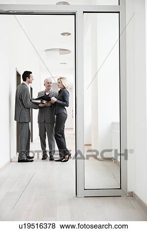 Businesspeople meeting in corridor View Large Photo Image Stock Photo - Businesspeople meeting in corridor. Fotosearch