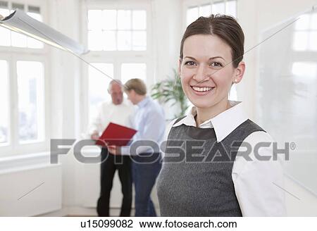 Businesswoman in office with colleagues View Large Photo Image Stock Image - Businesswoman in office with colleagues. Fotosearch