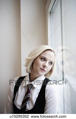 Businesswoman leaning against window View Large Photo Image Stock Image - Businesswoman leaning against window. Fotosearch